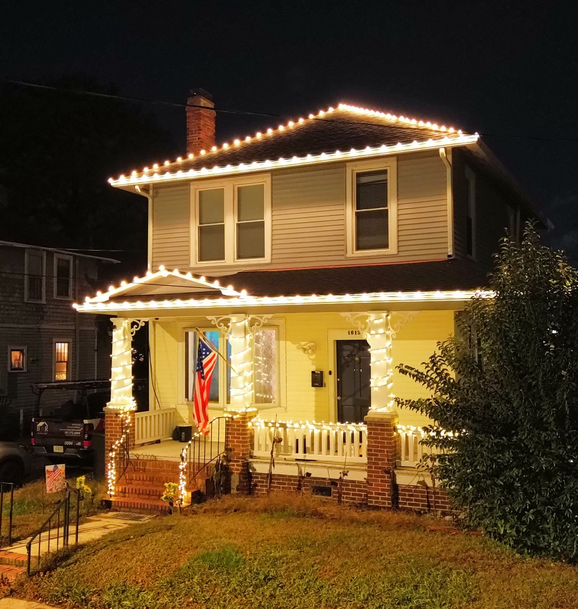 Christmas lights outlining roofline and porch columns