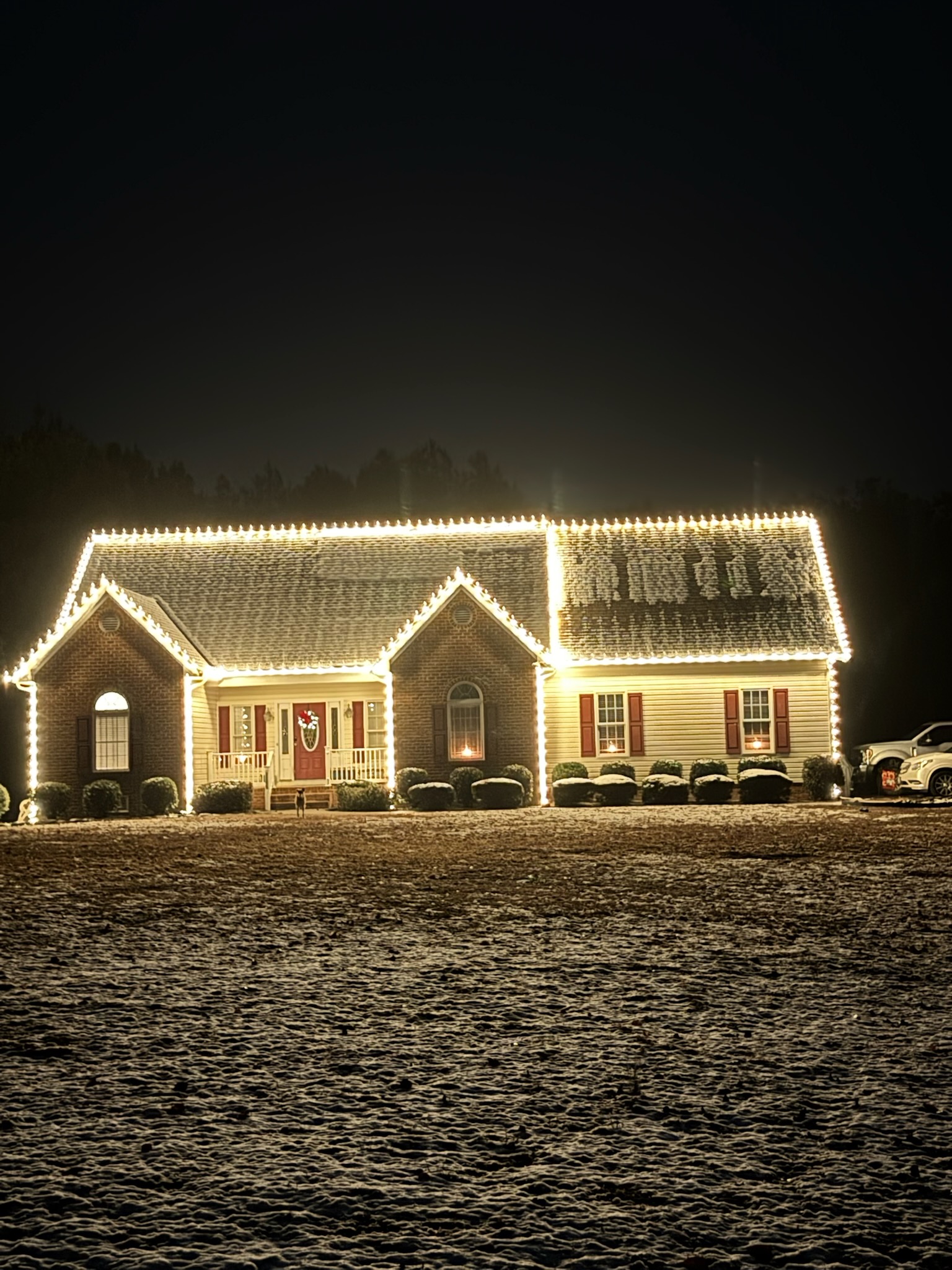Large home with professional Christmas lights outlining the roofline