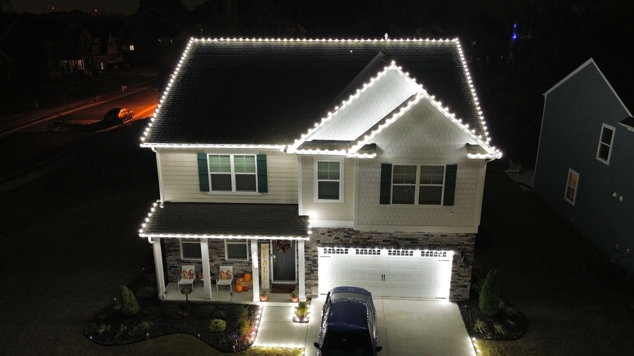 Bright white Christmas lights outlining a two-story home